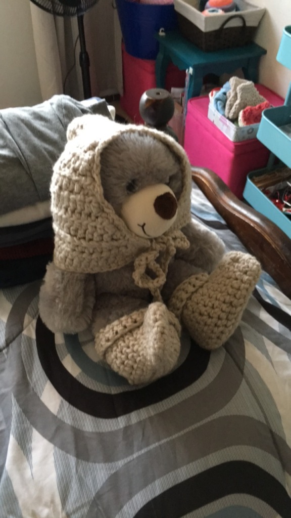 crochet hat and booties on teddy bear