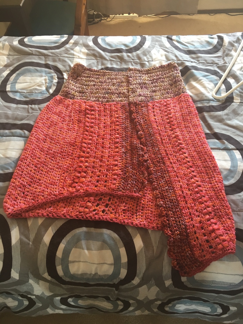 finished shawl with red and pink yarn
