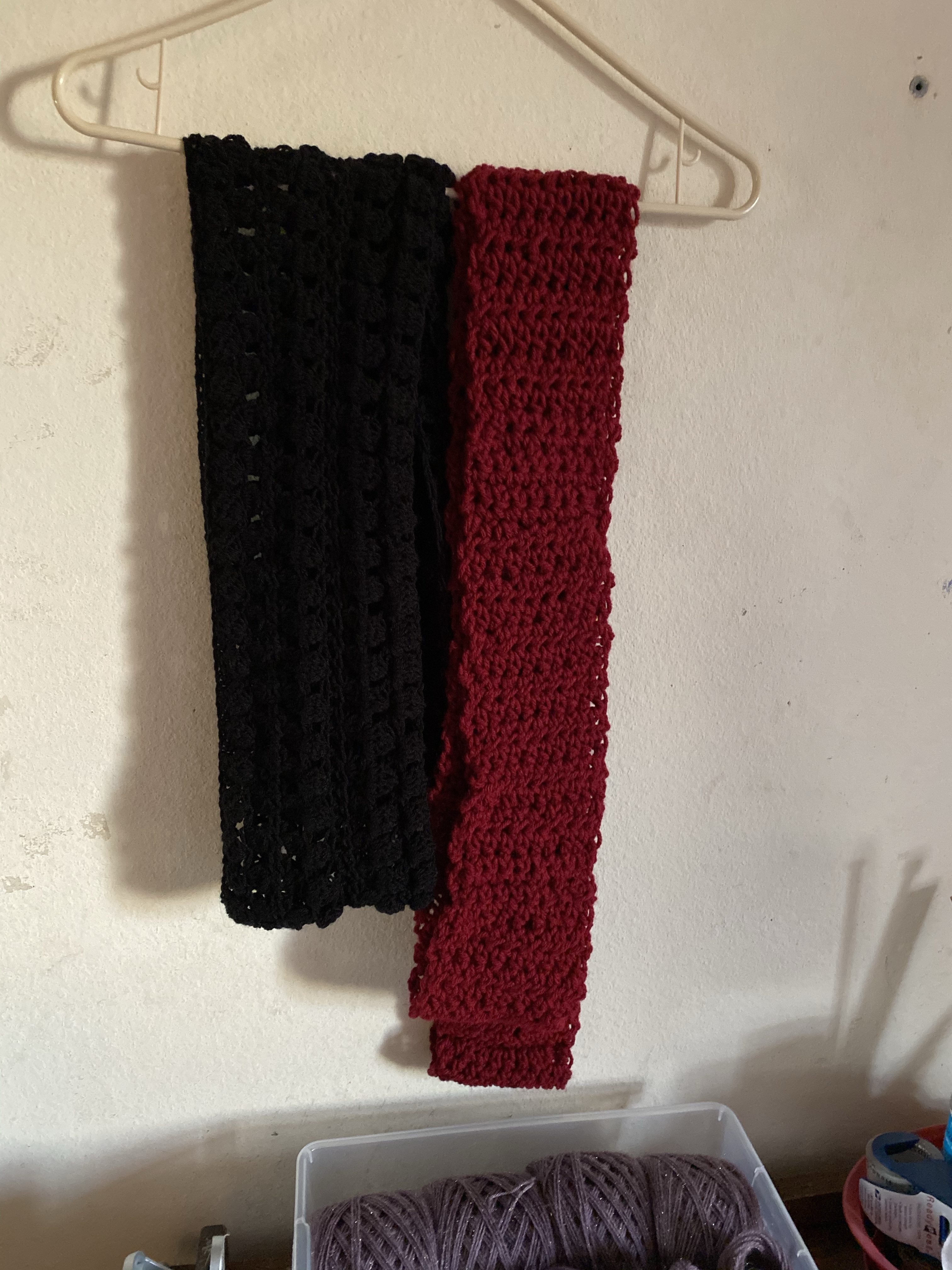 Black scarf on left, Red crochet scarf on the right